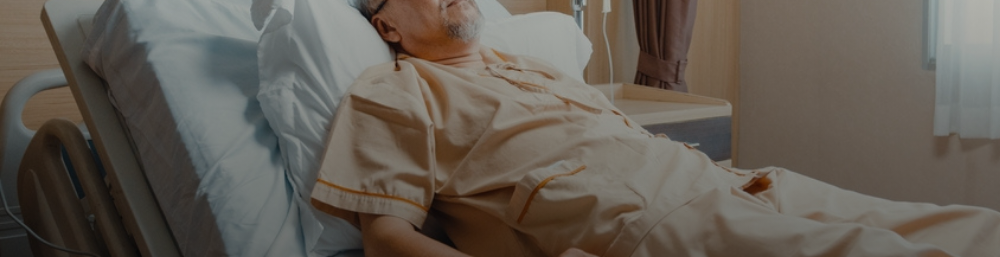 An Elderly Patient laying on a Bed