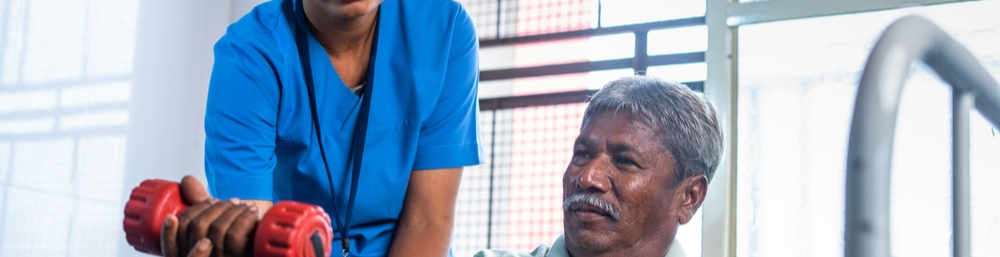 A caretaker helping an elderly with oestoporosis