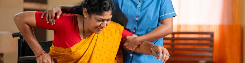 An Caretaker Helping an Elderly