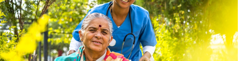 A Nurse and Eldery On A Wheelchair